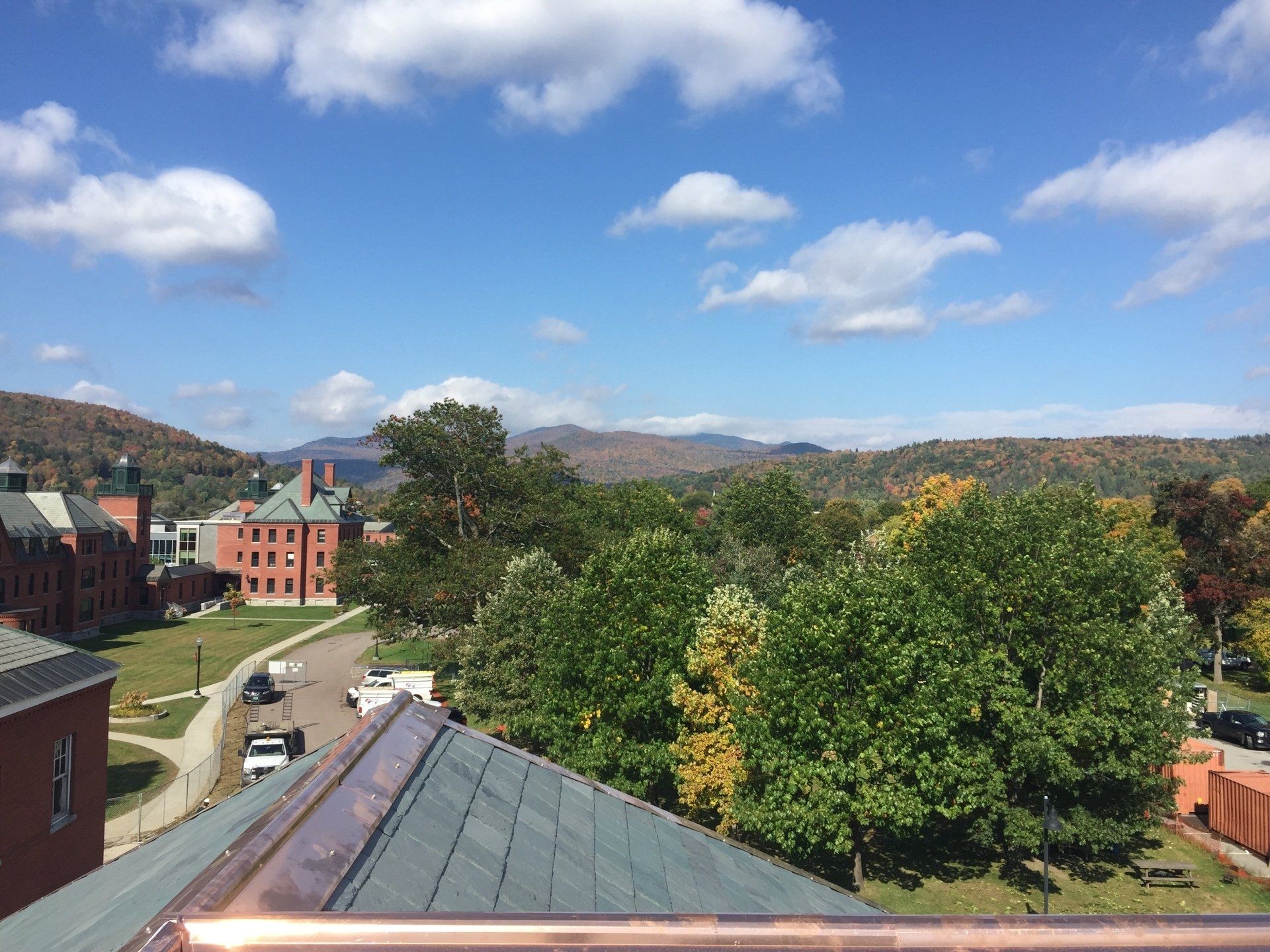 A view of a city from the top of a building on a sunny day.