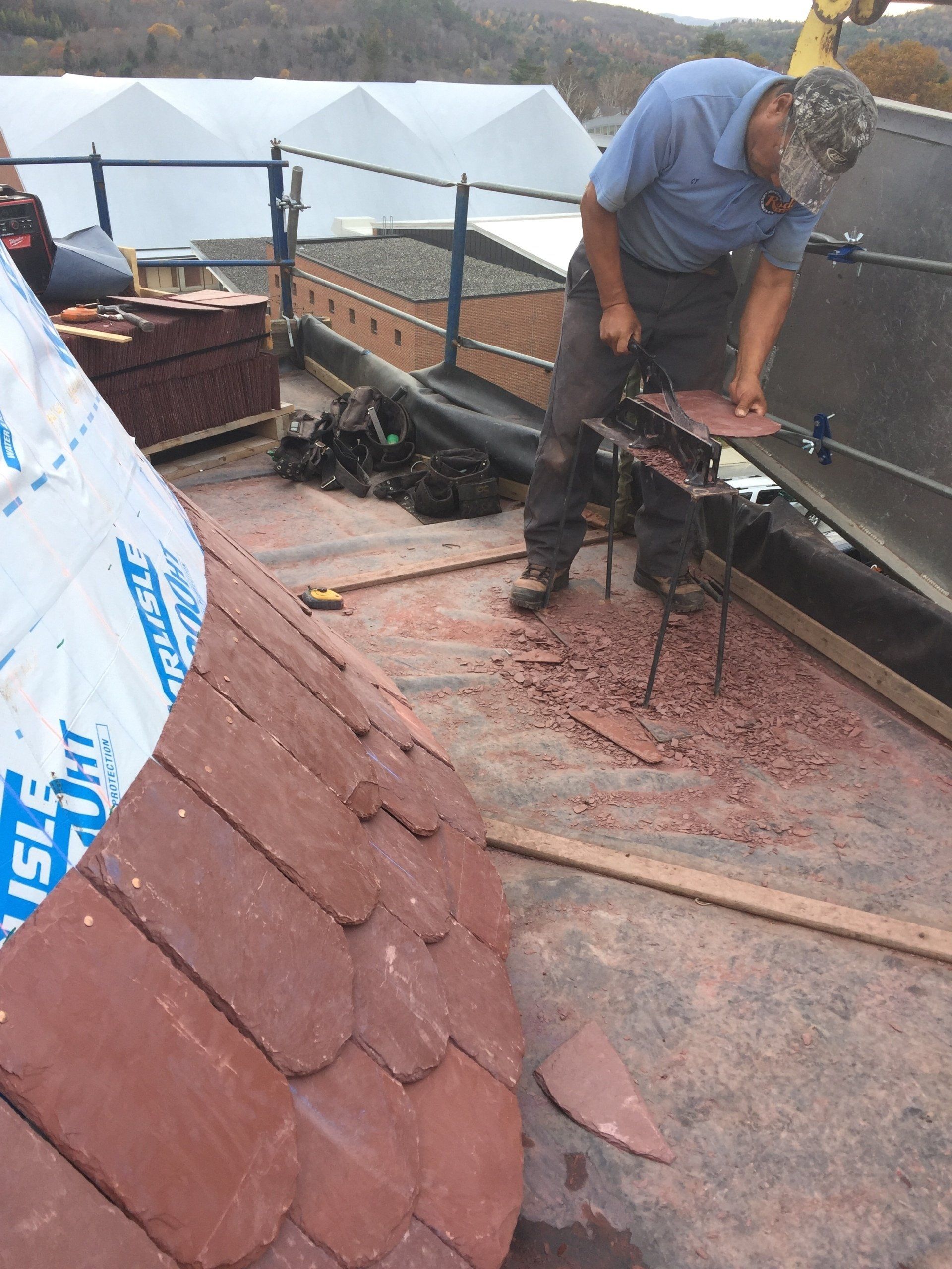 A man is working on a roof with a bag that says insulation on it