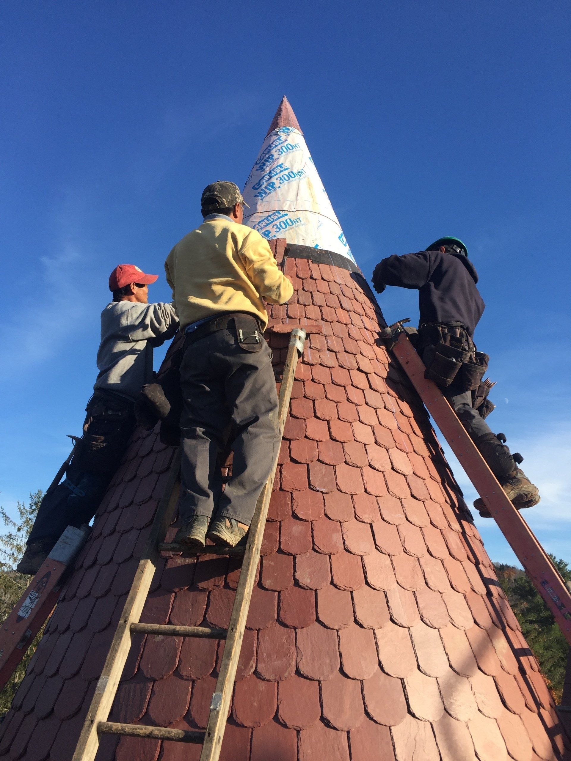 A group of men are working on the roof of a building