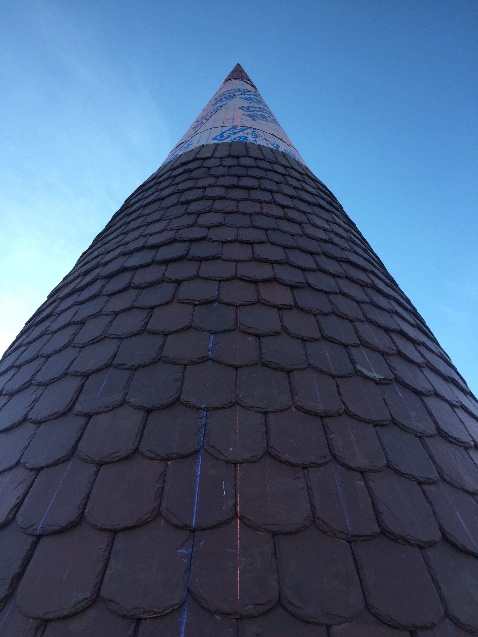 Looking up at a very tall building with a blue sky in the background