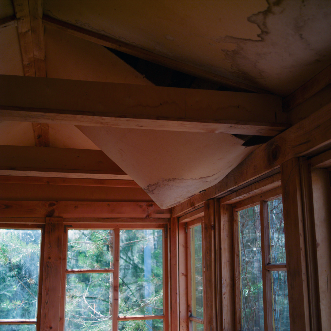 Deteriorating ceiling of home showing leaks and water damage