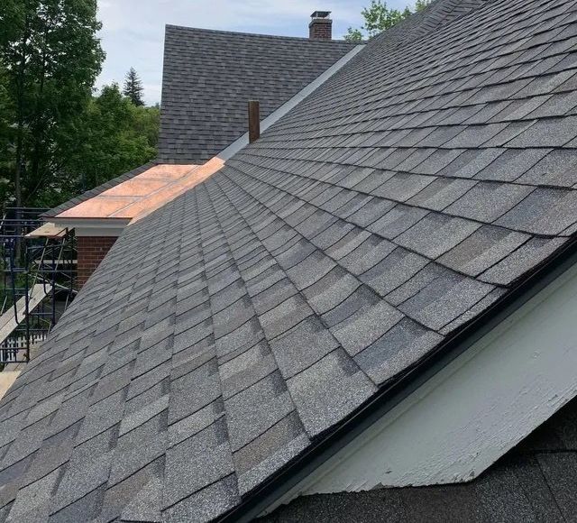 A Vermont home with asphalt shingles and copper flashing installed by Rodd Roofing Company