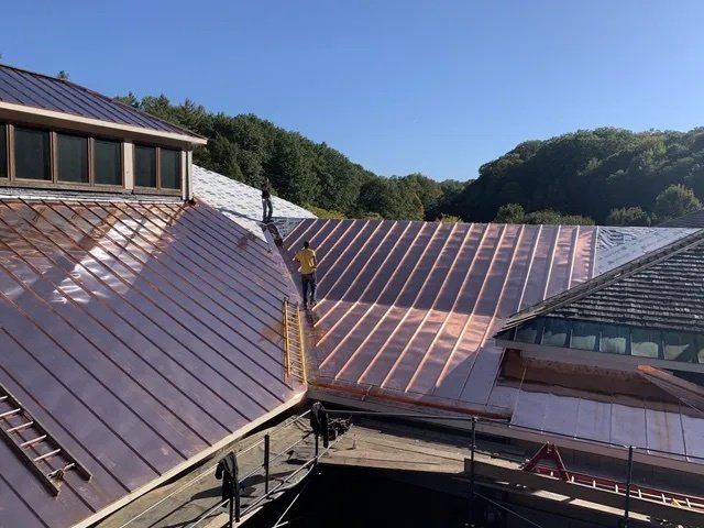 A copper standing seam roof installed by Rodd Roofing on a house in Vermont