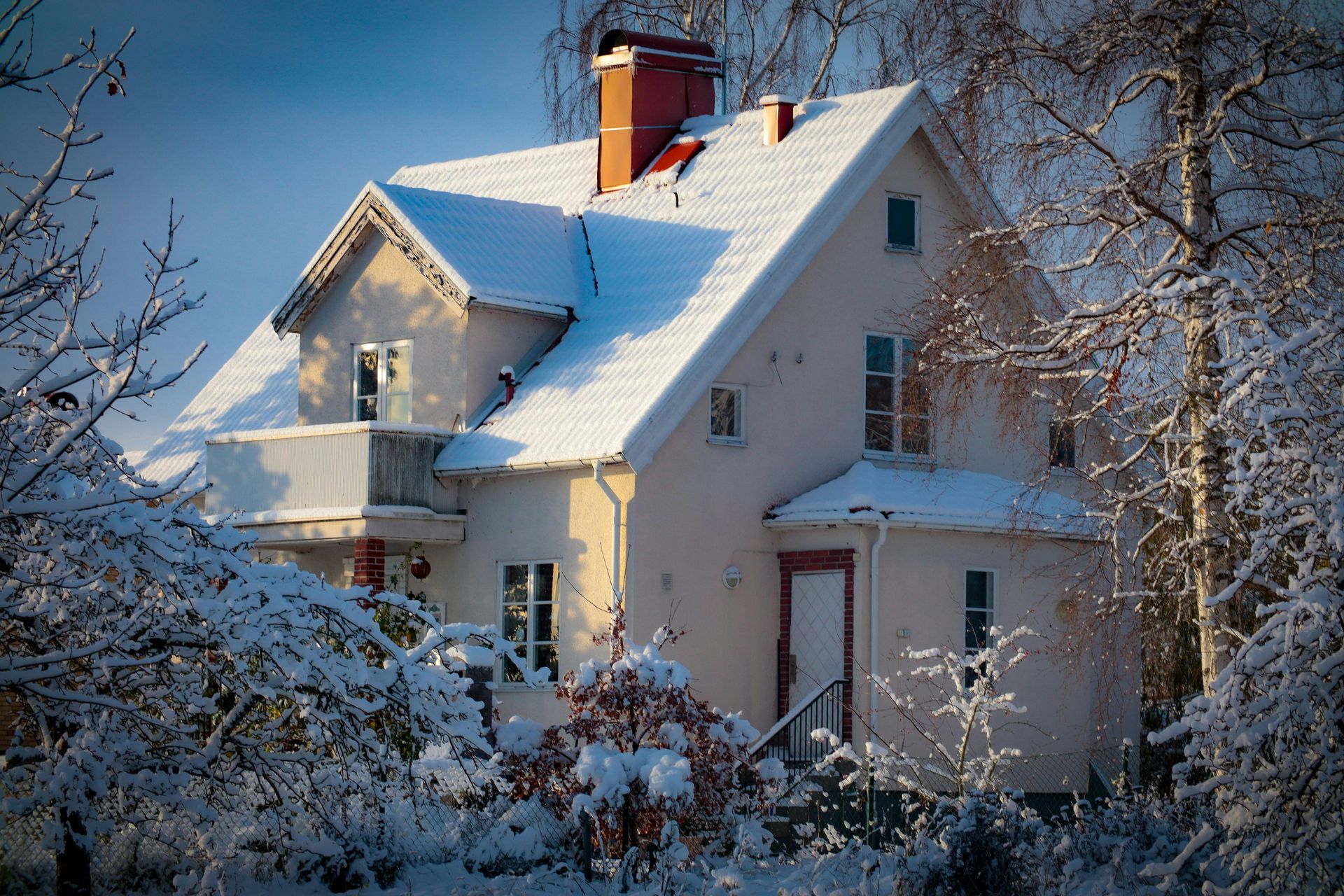 A house in a Vermont setting with a slight dusting of snow and frost on it.