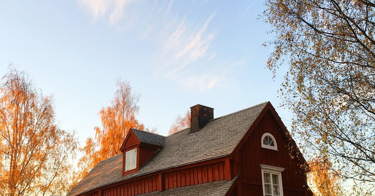 A red house with asphalt shingles installed by Rodd Roofing, Vermont Roofing Contractor