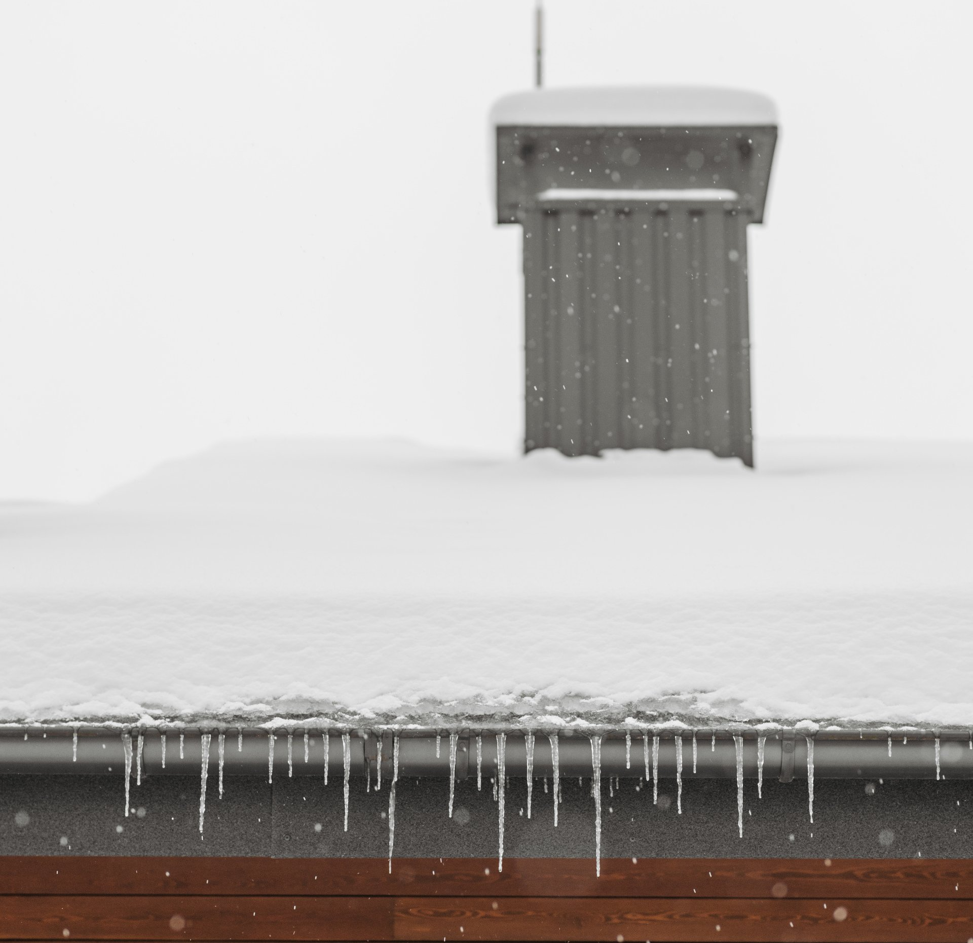 Building roof with heavy snowfall on top of it