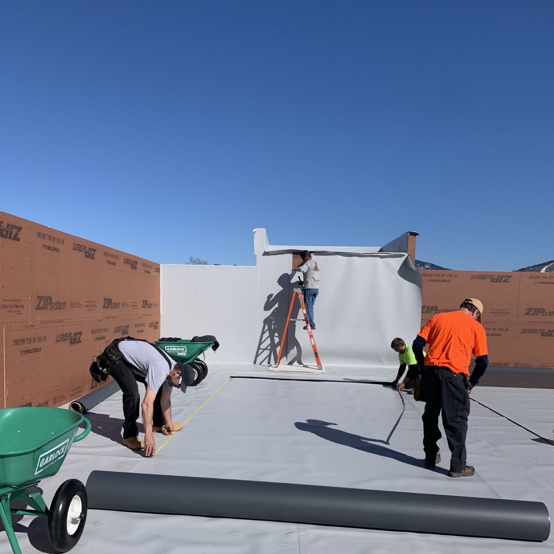 Rodd Roofing installing white single ply roof on a commercial building in Vermont