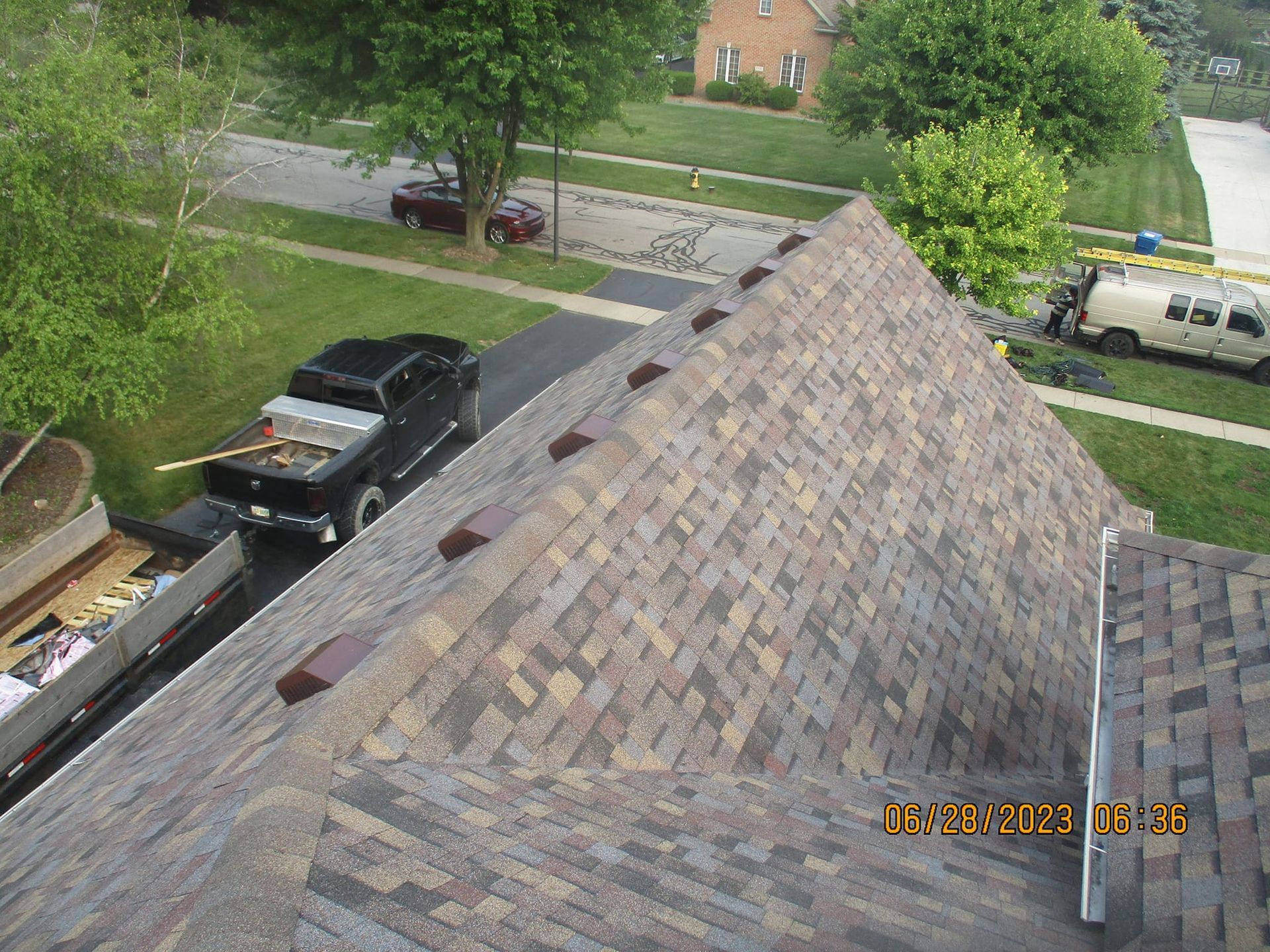 An aerial view of a roof with a truck parked on the side of it.