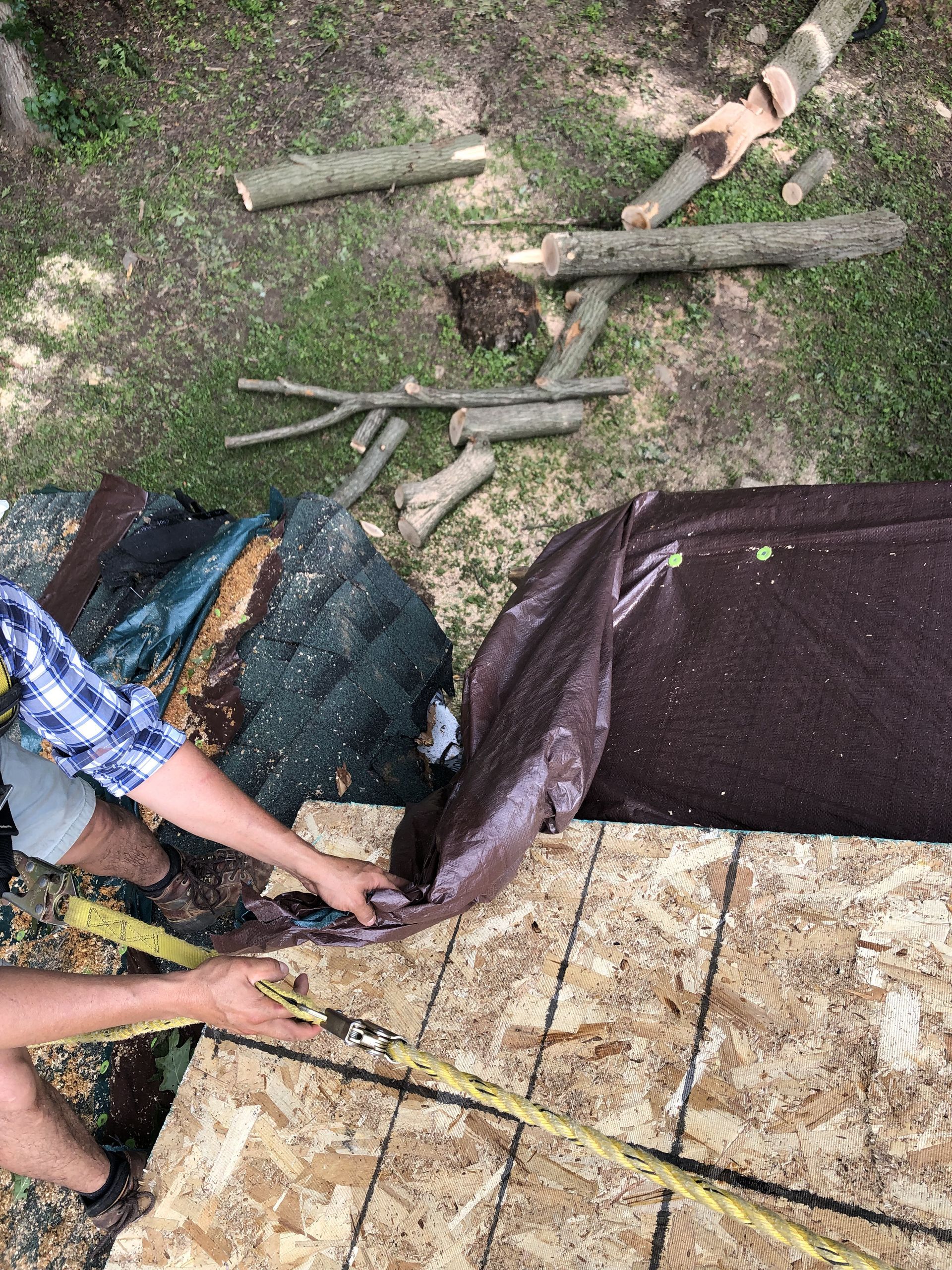 A man is using a drill to drill a hole in a piece of wood.