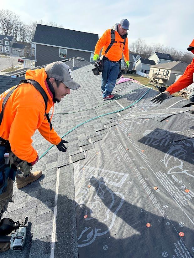 Roofer nailing shingles
