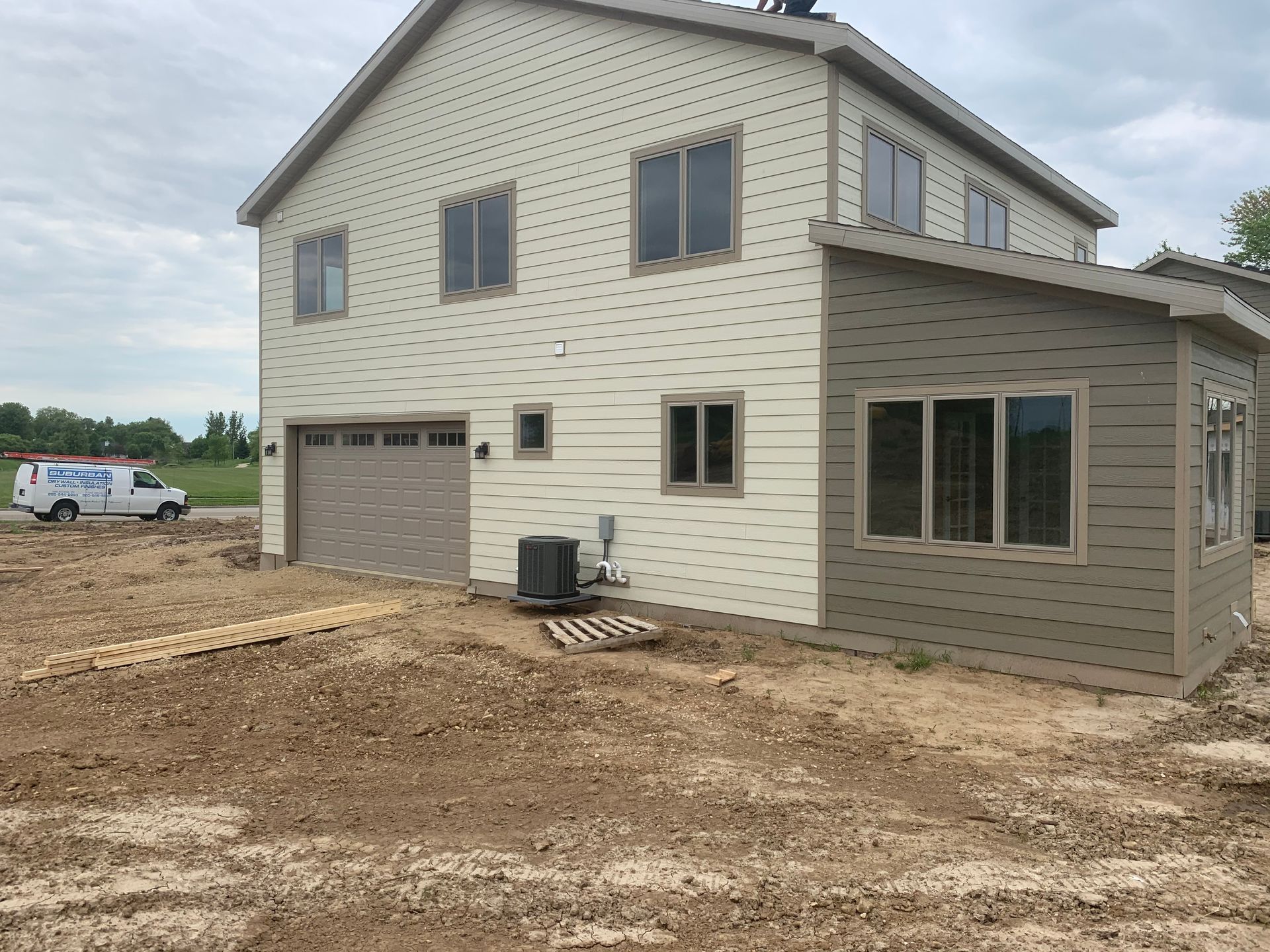 A man is using a drill to drill a hole in a piece of wood.
