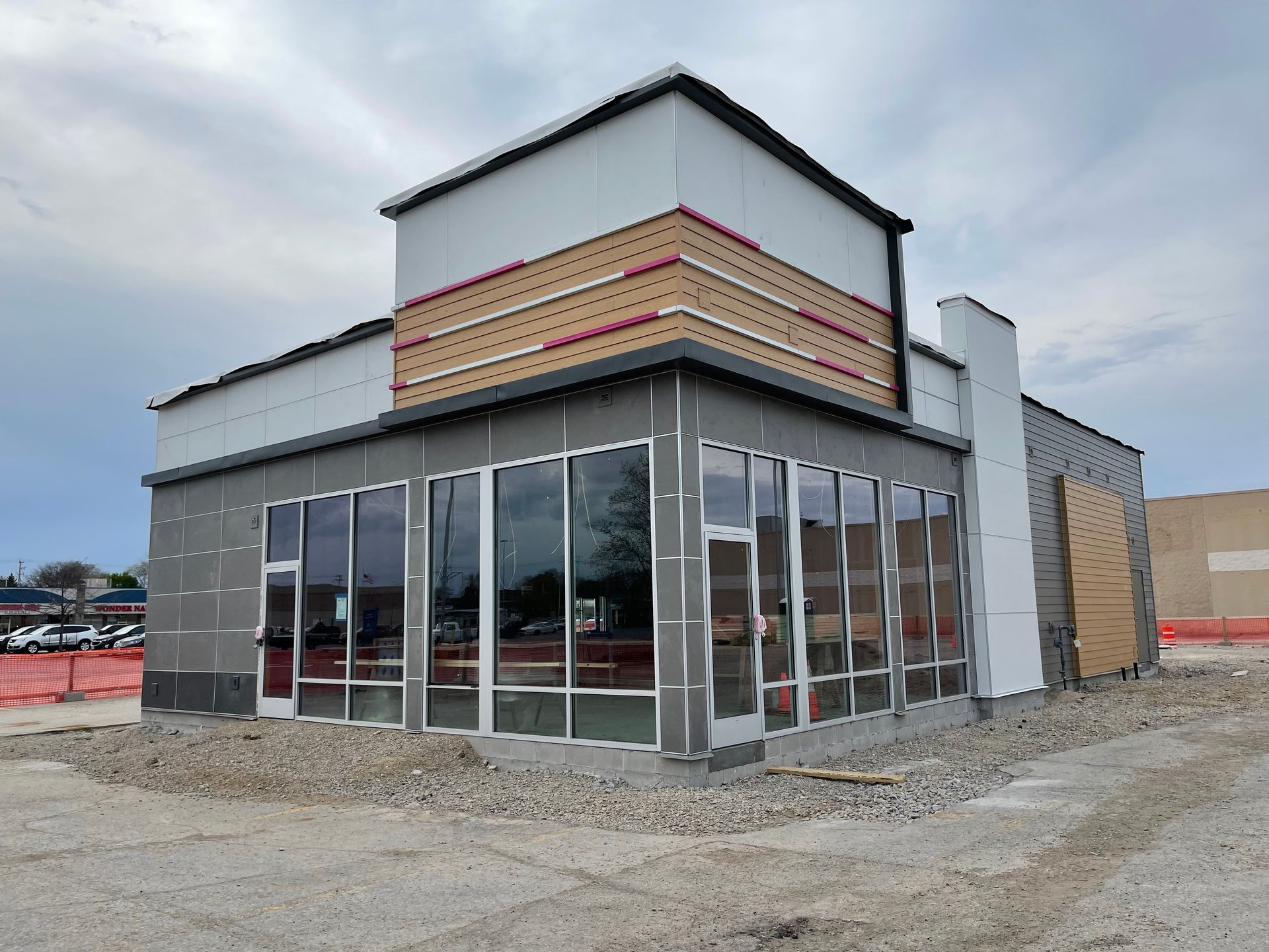 A wooden balcony with a chair and a view of the mountains.