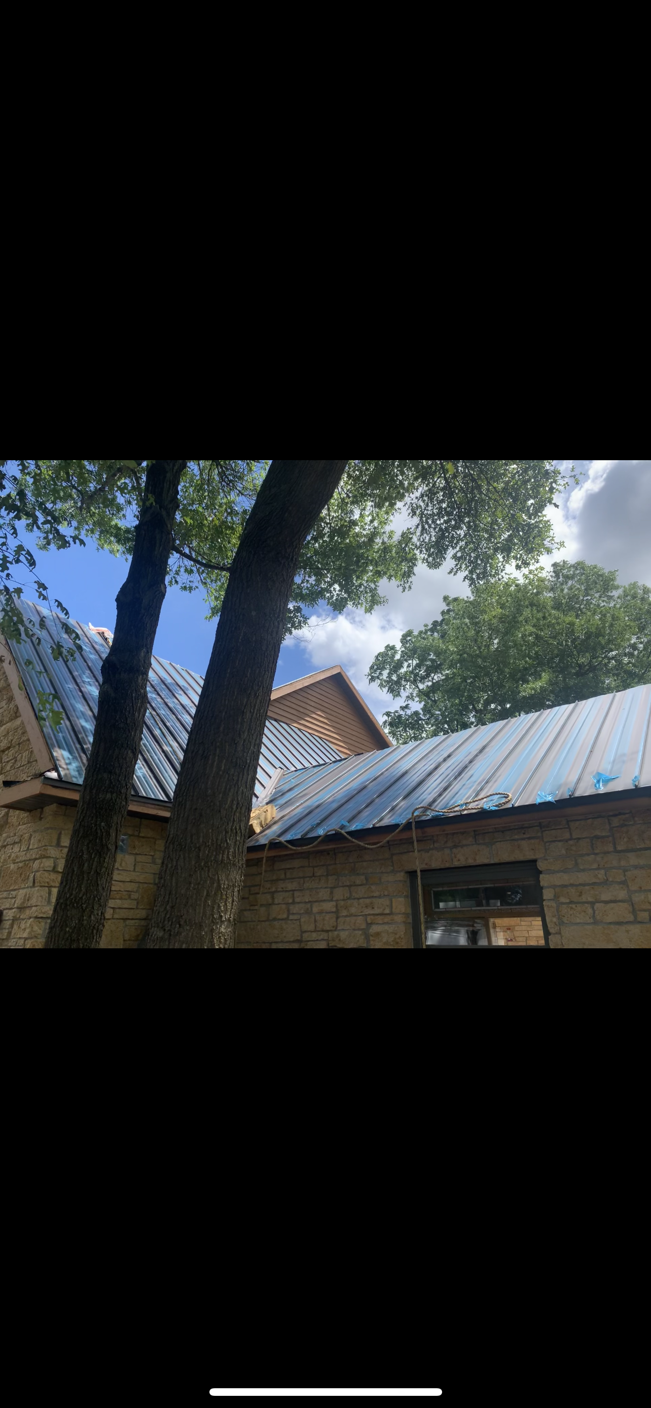 A close up of a gutter on the roof of a house.