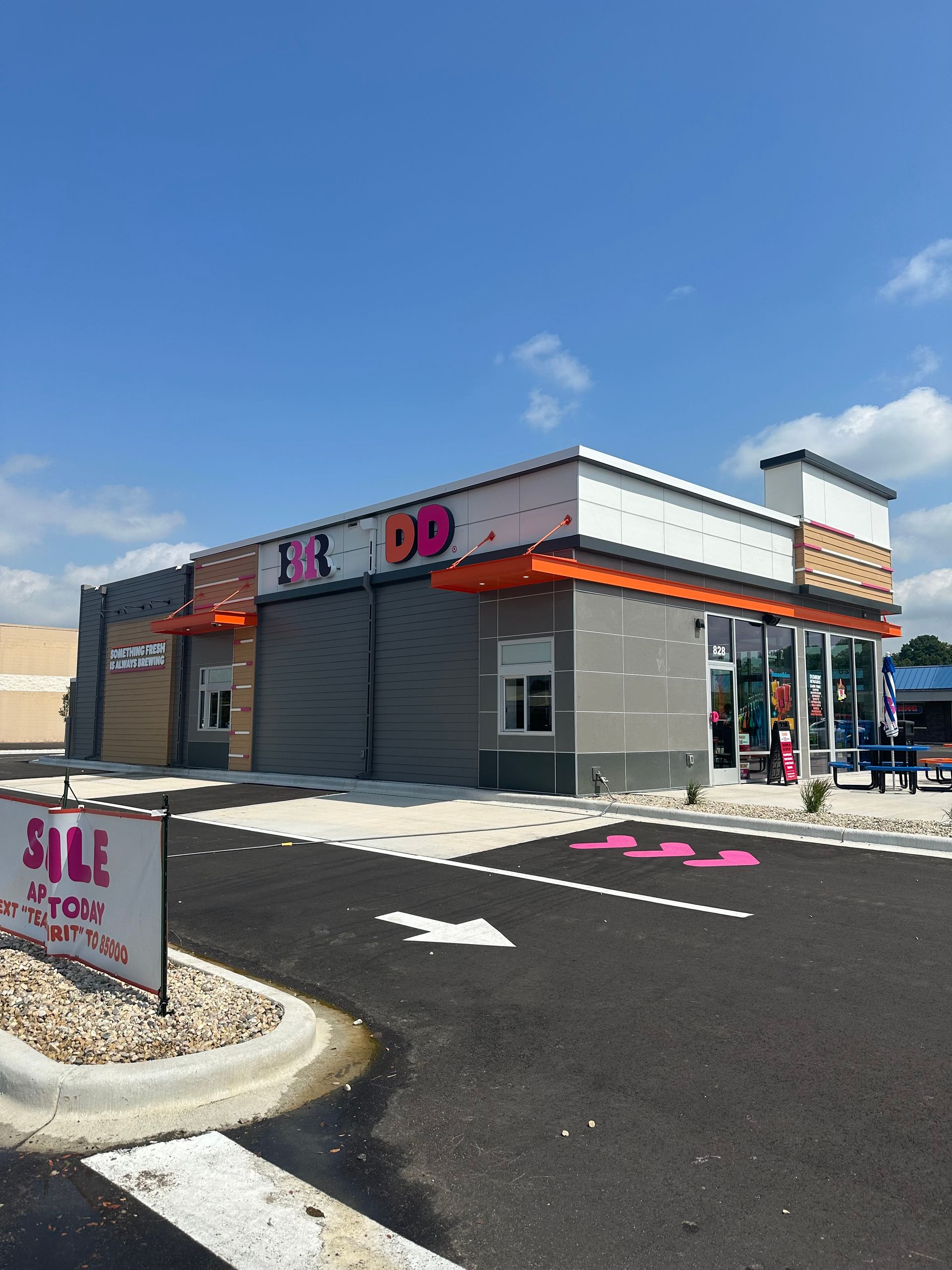 A roof with a lot of shingles on it and a house in the background.