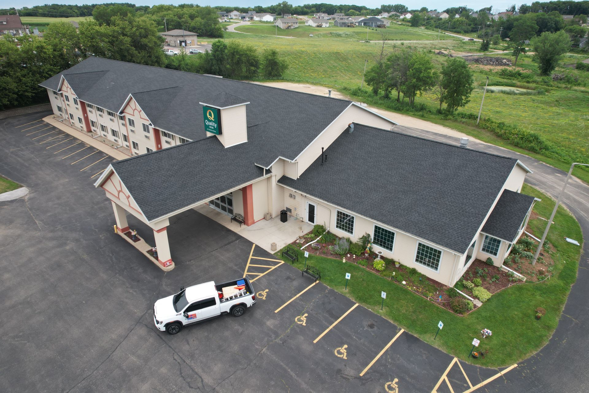 An aerial view of a super 8 hotel in a small town.