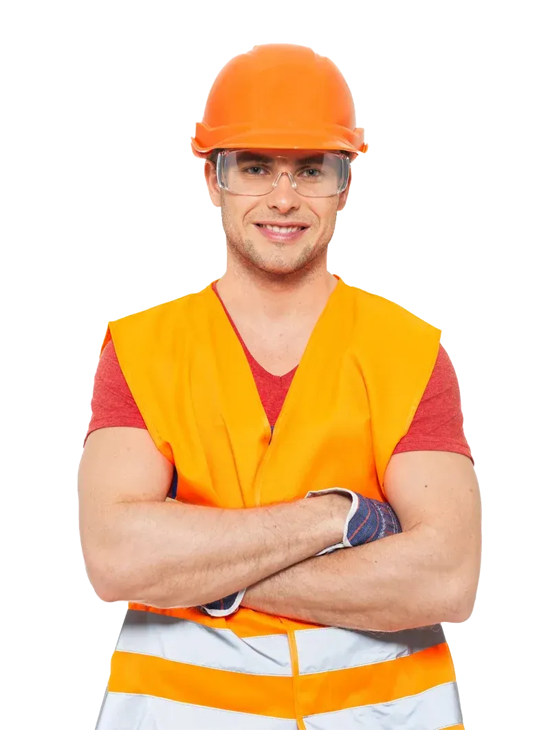 A man wearing a hard hat and safety glasses is standing with his arms crossed.