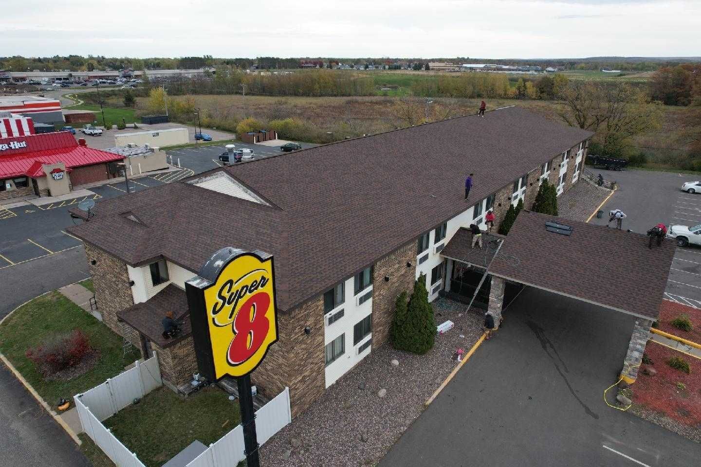 An aerial view of a super 8 hotel in a small town.