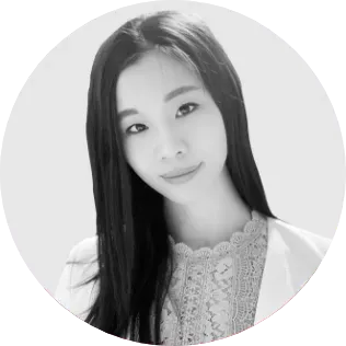 A black and white photo of a woman with long hair in a circle.