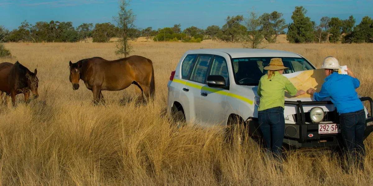 A group of business people are sitting at a table having a meeting.