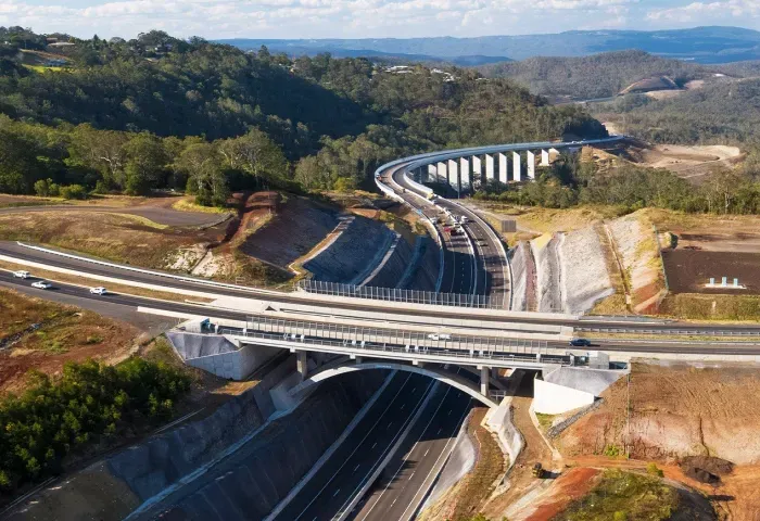 An aerial view of a highway with a bridge over it.