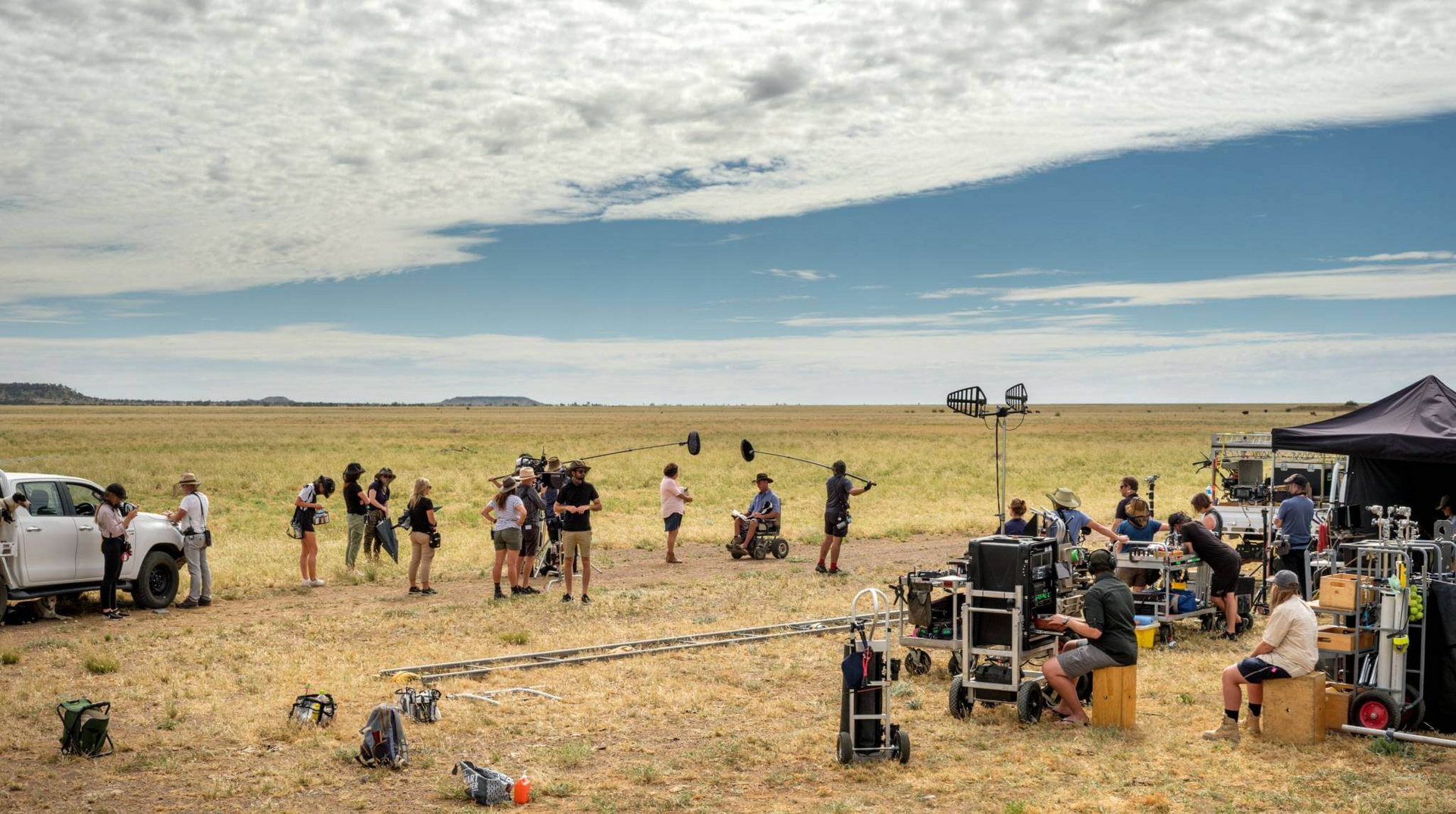 A group of people are standing in a field.