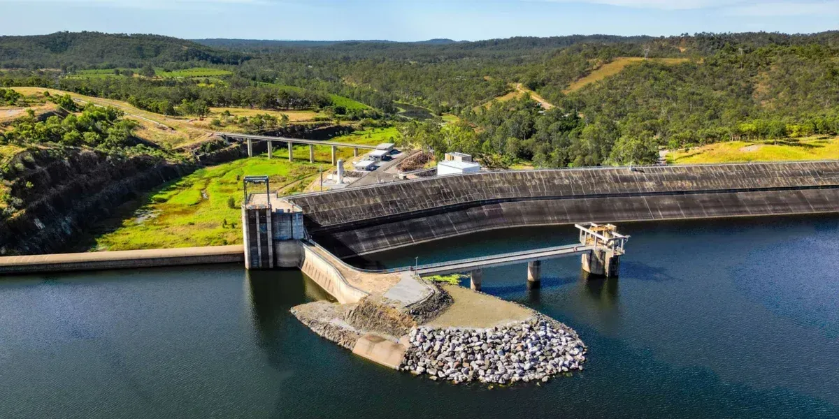 An aerial view of a large body of water with a bridge over it.