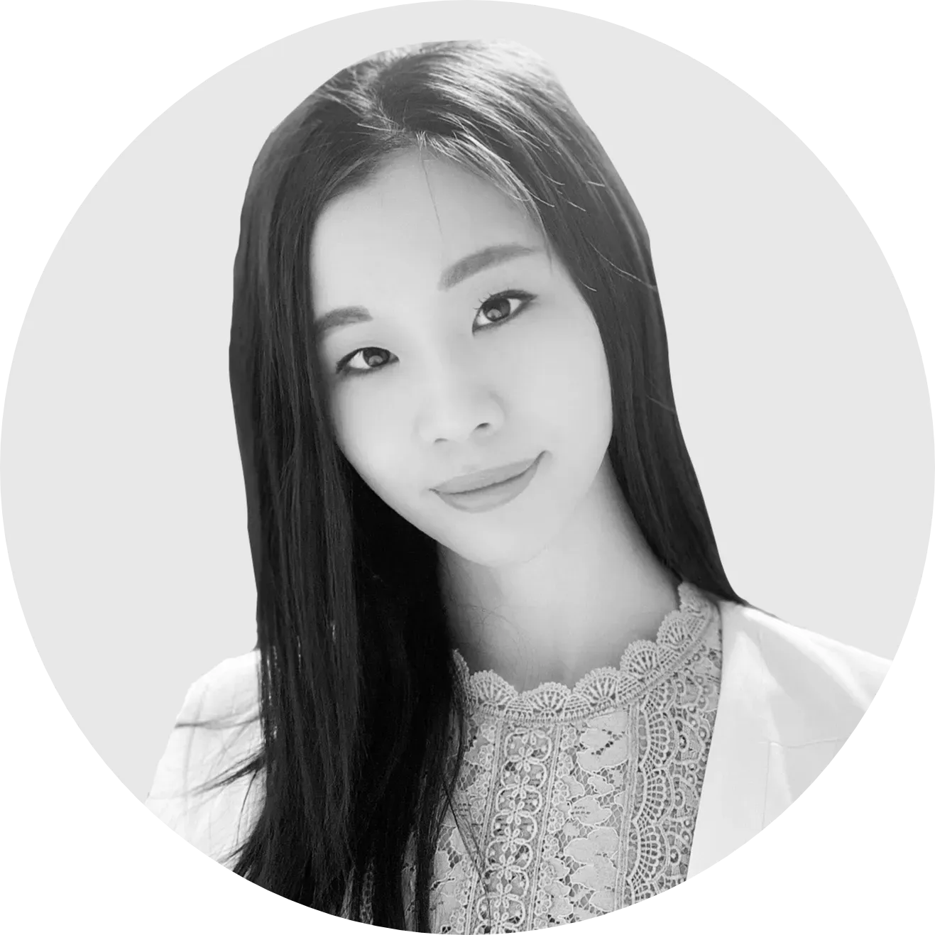 A black and white photo of a woman with long hair in a circle.