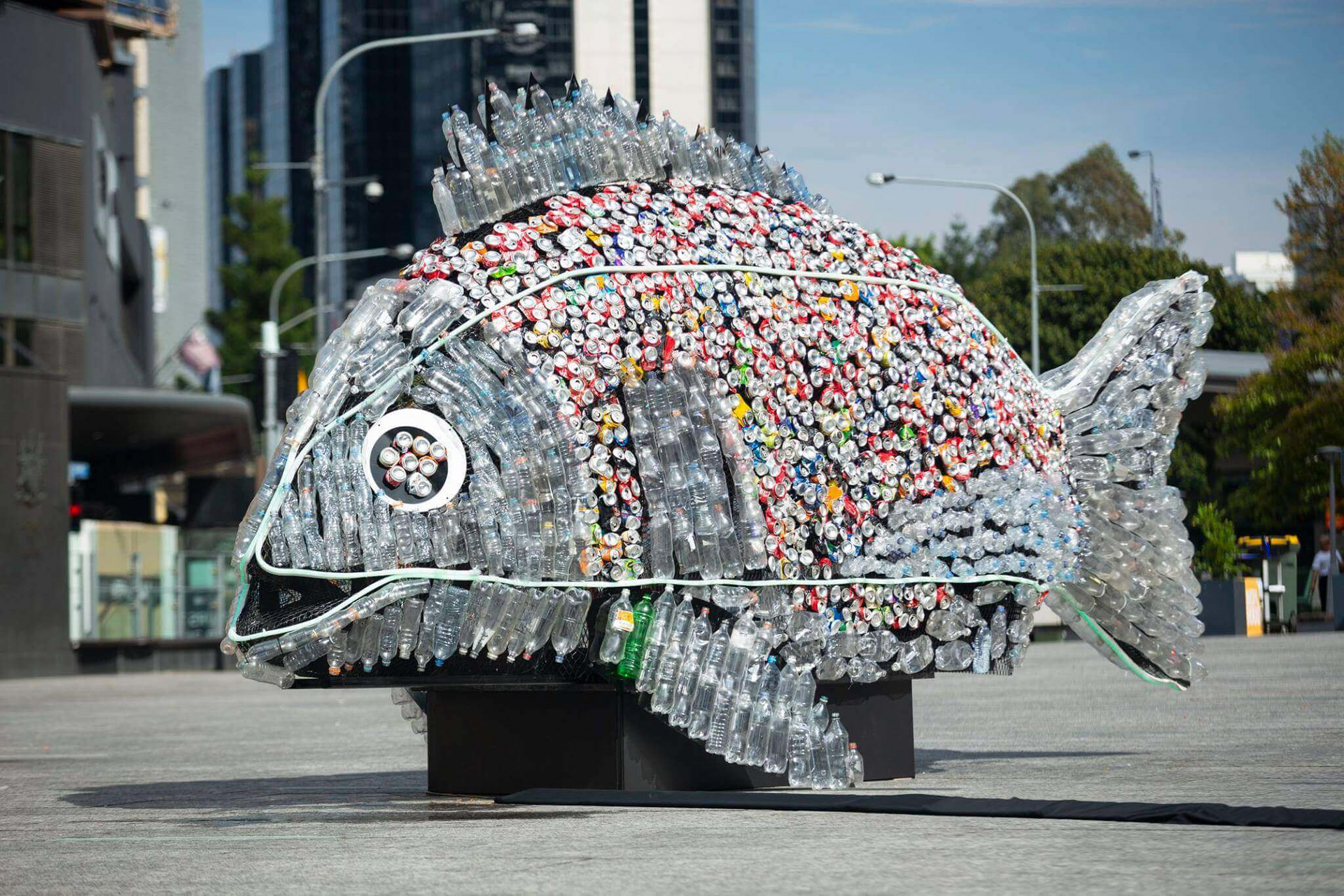 A statue of a fish made out of plastic bottles