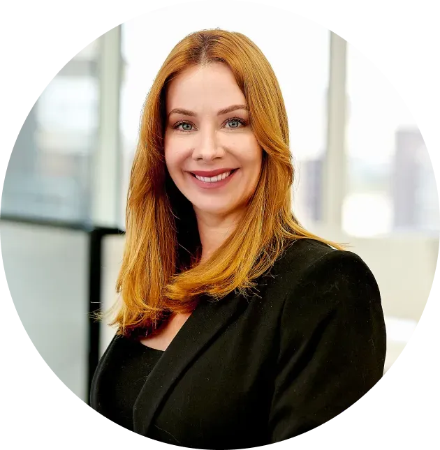 A woman in a black jacket is smiling in a circle.