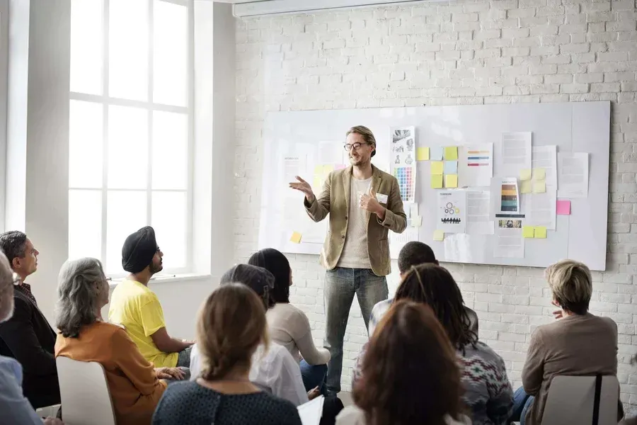 A man is giving a presentation to a group of people.