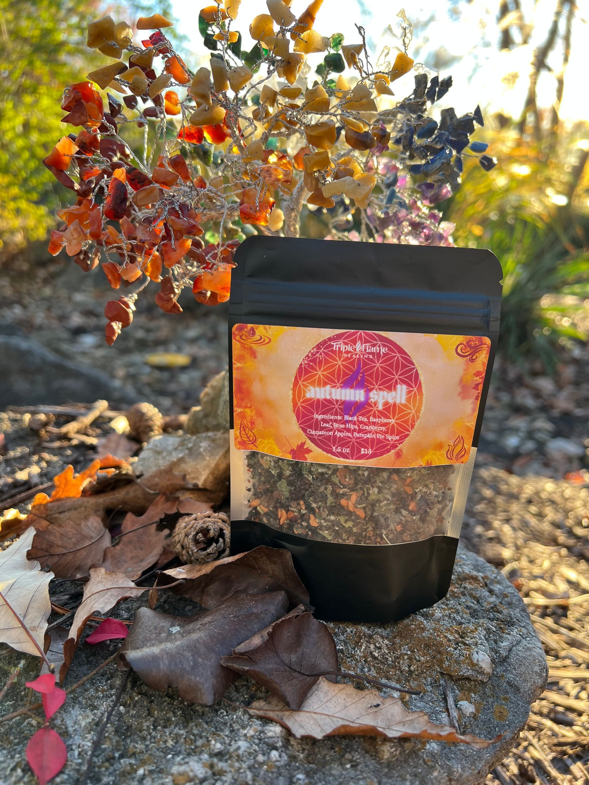 A bag of herbs is sitting on top of a pile of leaves.