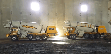 Two concrete mixer trucks