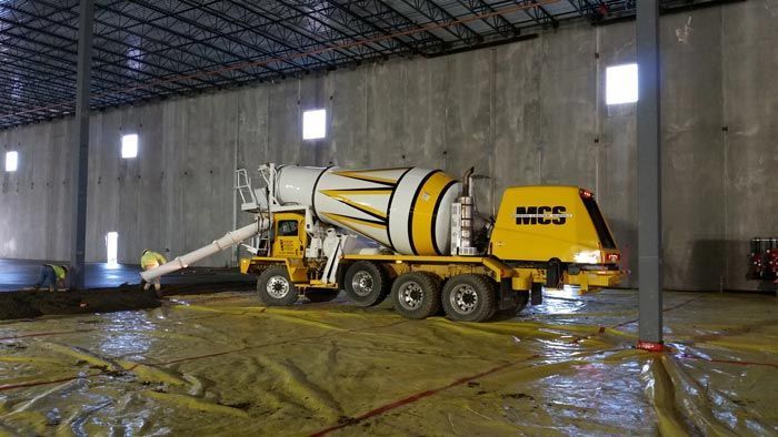 Yellow and white concrete mixer truck