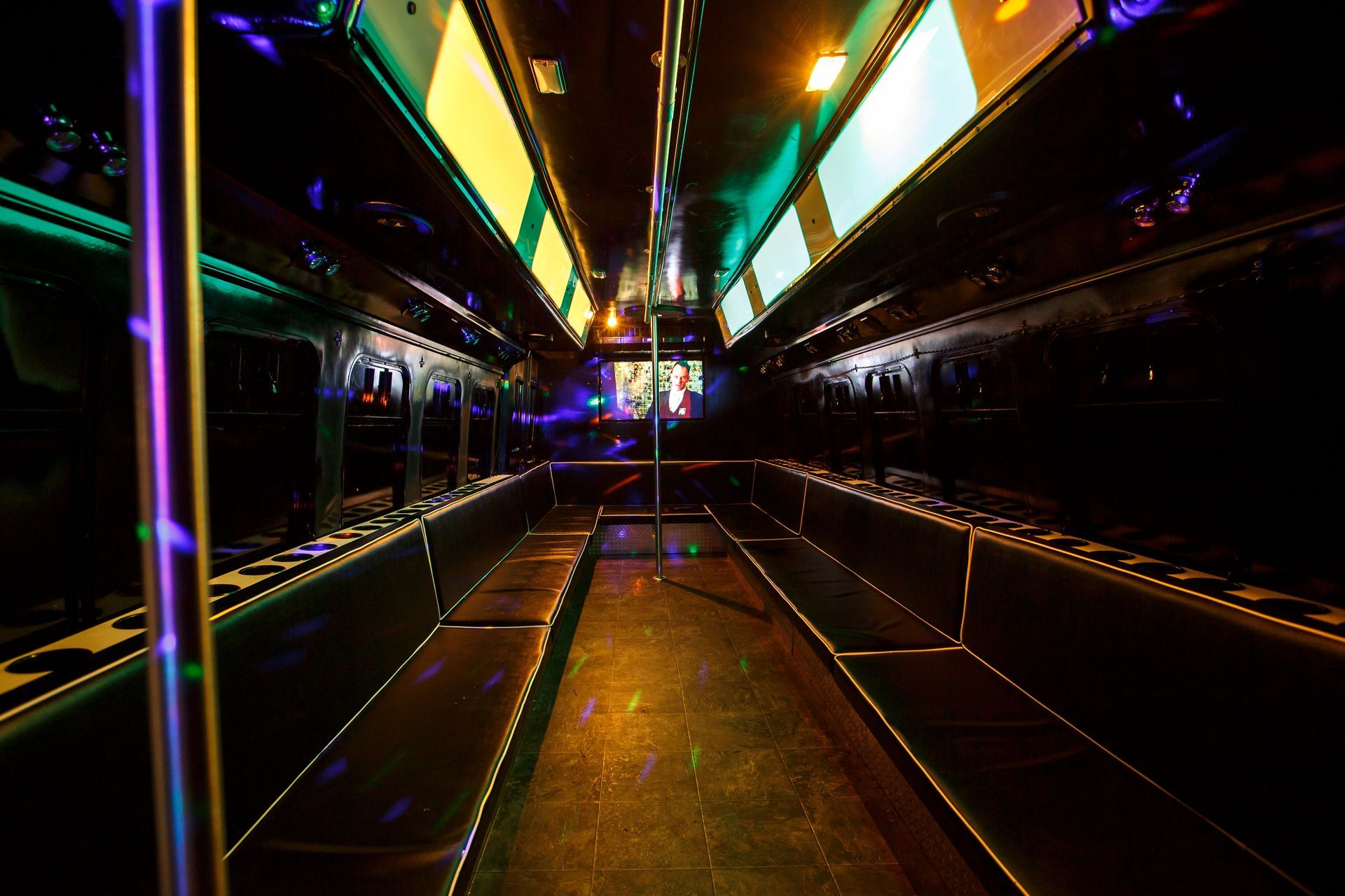Neon-lit subway car interior with reflective walls and glowing ceiling panels