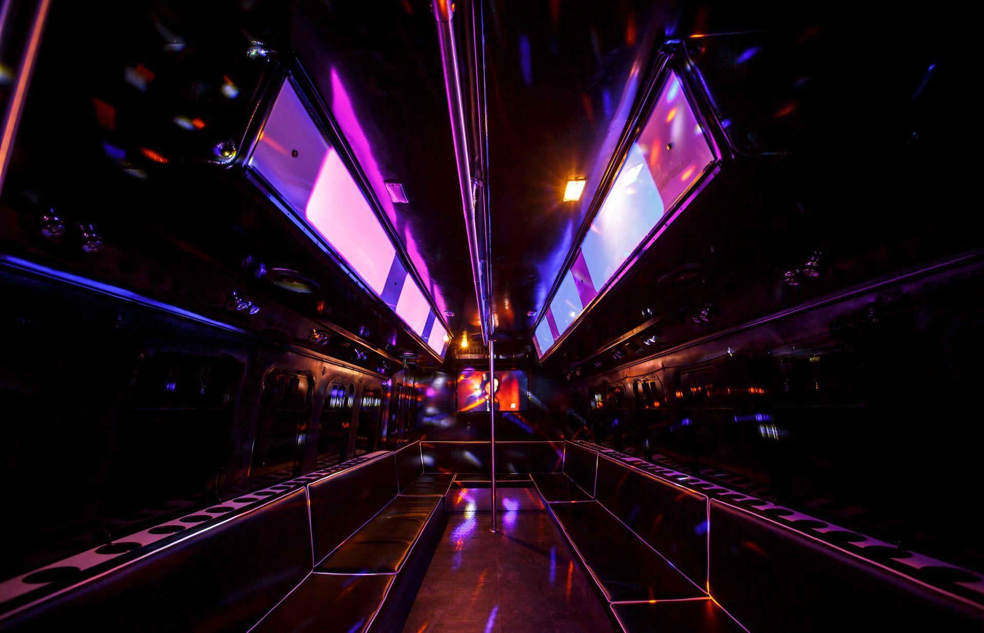 Futuristic neon-lit corridor with purple and blue glowing panels and reflective floor