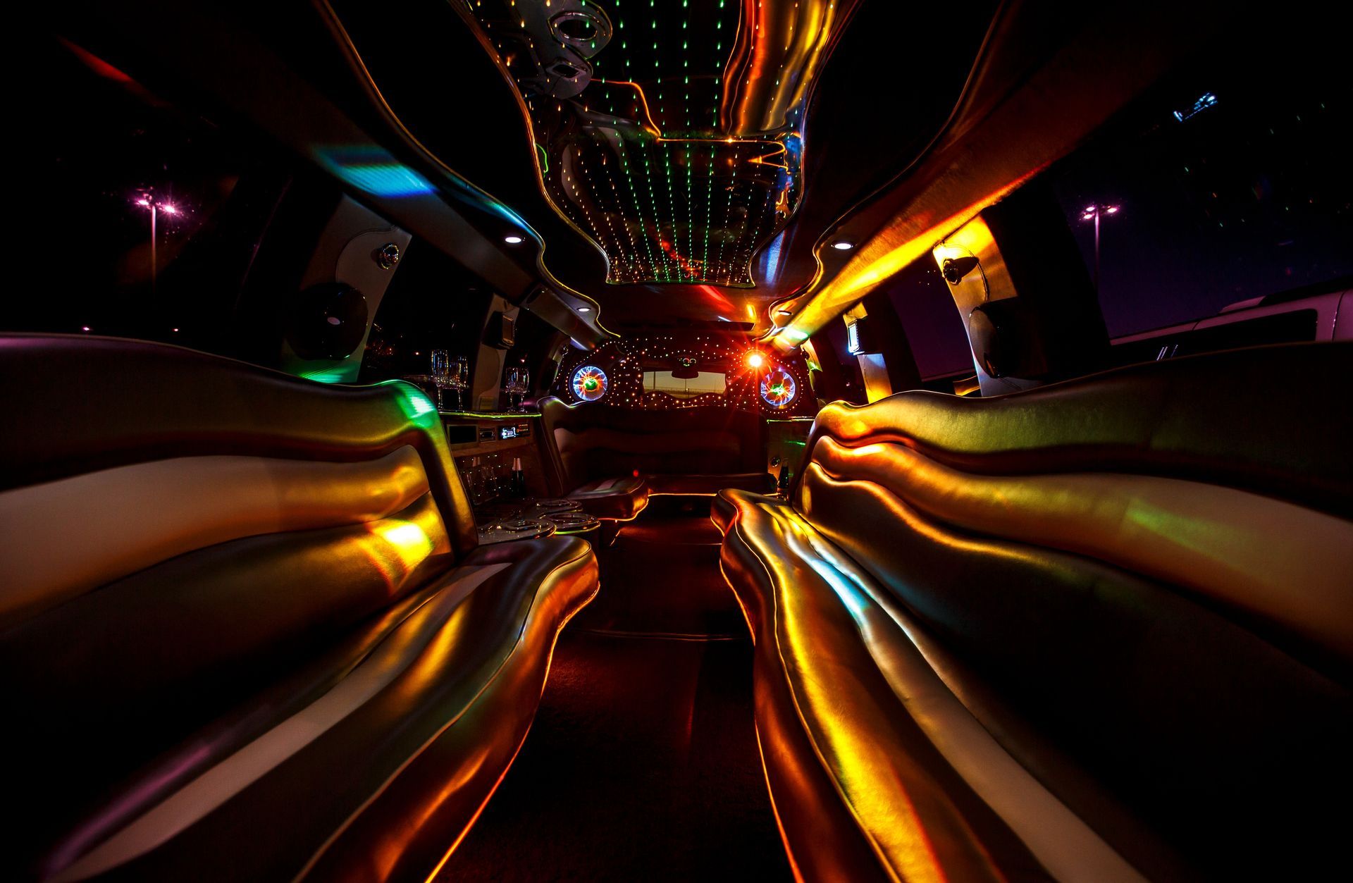 Abstract neon light streaks in a dark tunnel, glowing orange, gold, blue, and red