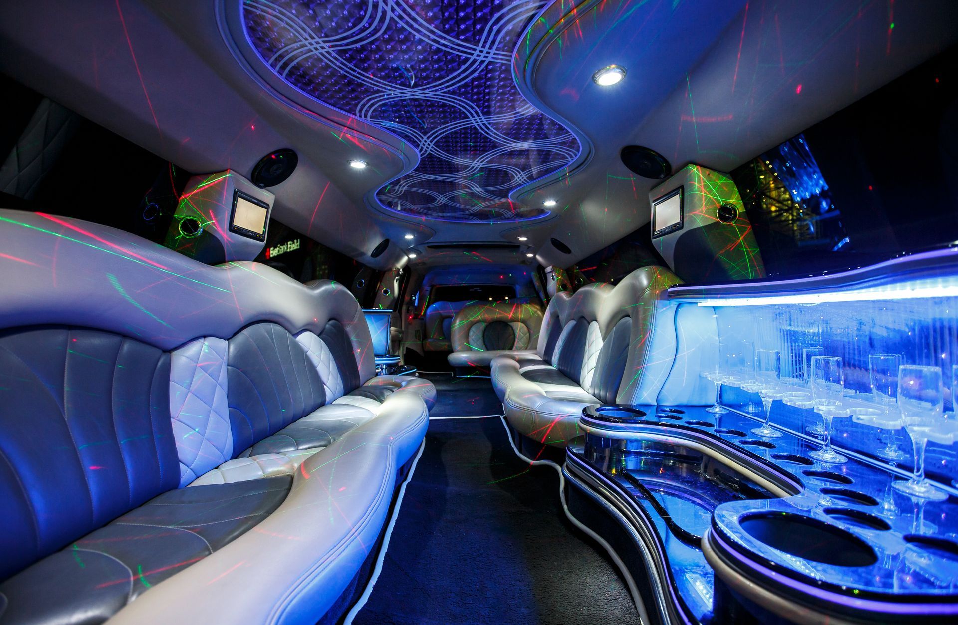 Luxurious party limo interior with blue LED lighting and plush leather seats
