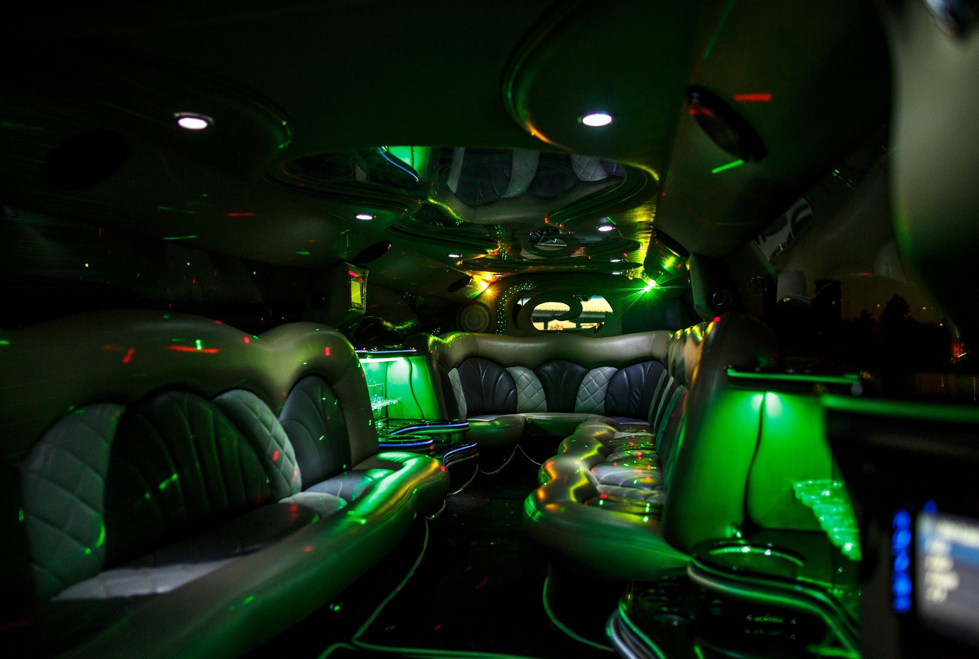 Futuristic vehicle interior with glowing green lights and sleek leather seats