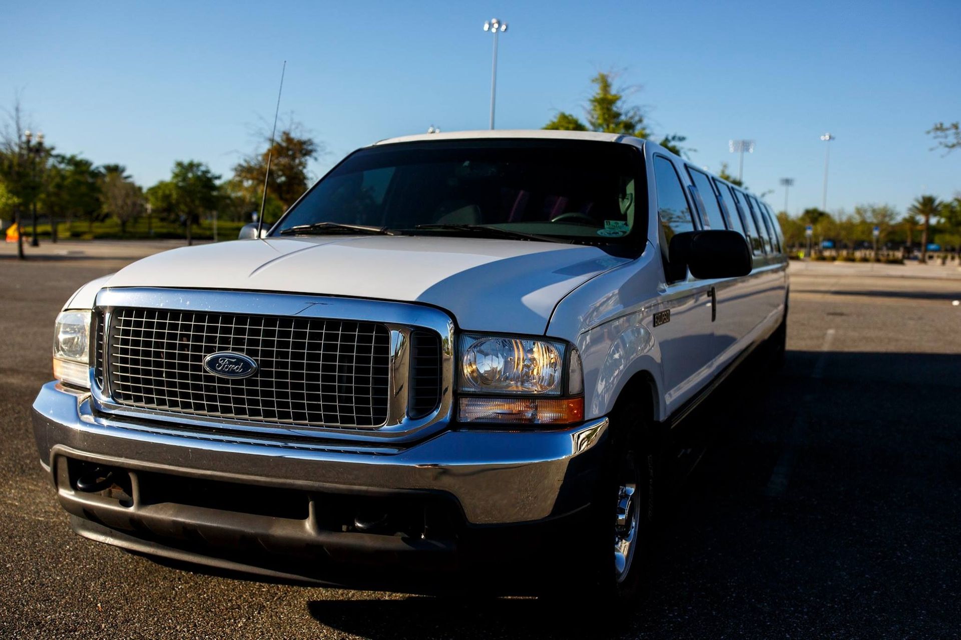 White SUV parked on an open lot under a clear sky