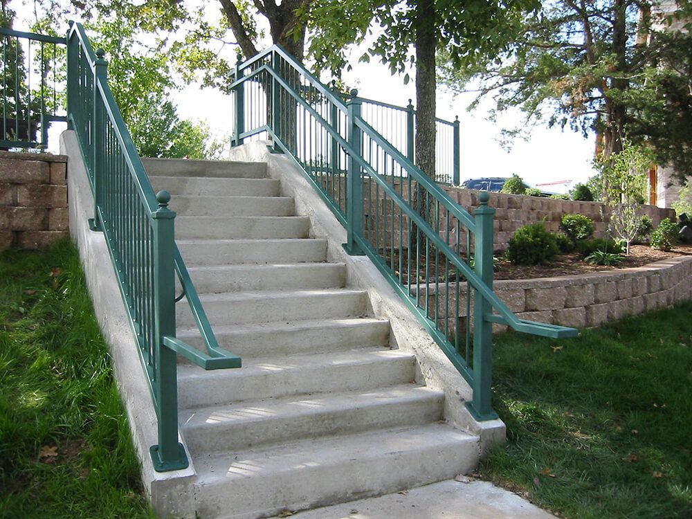 A set of stairs with a green railing | Railing company springfield mo