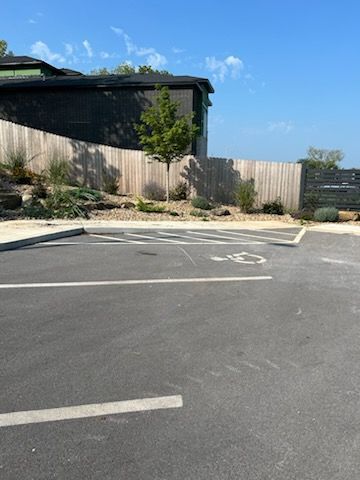 A parking lot with a handicap sign in the middle of it.