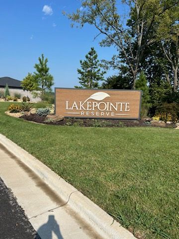 A lakepointe reserve sign is sitting on the side of the road.