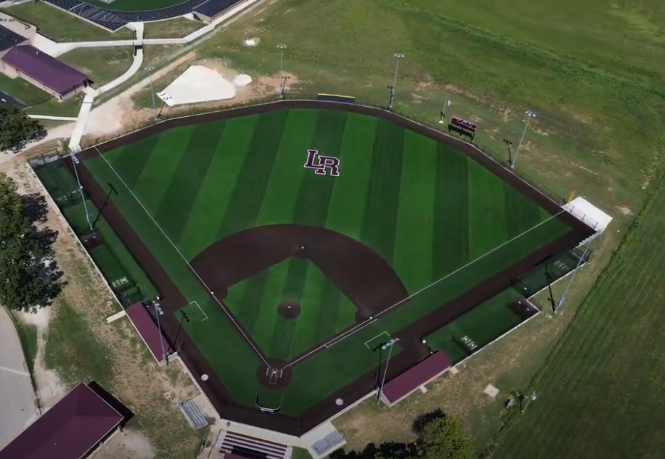 An aerial view of a baseball field with the letter b on it