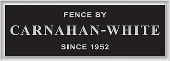 A black sign that says fence by carnahan-white since 1952