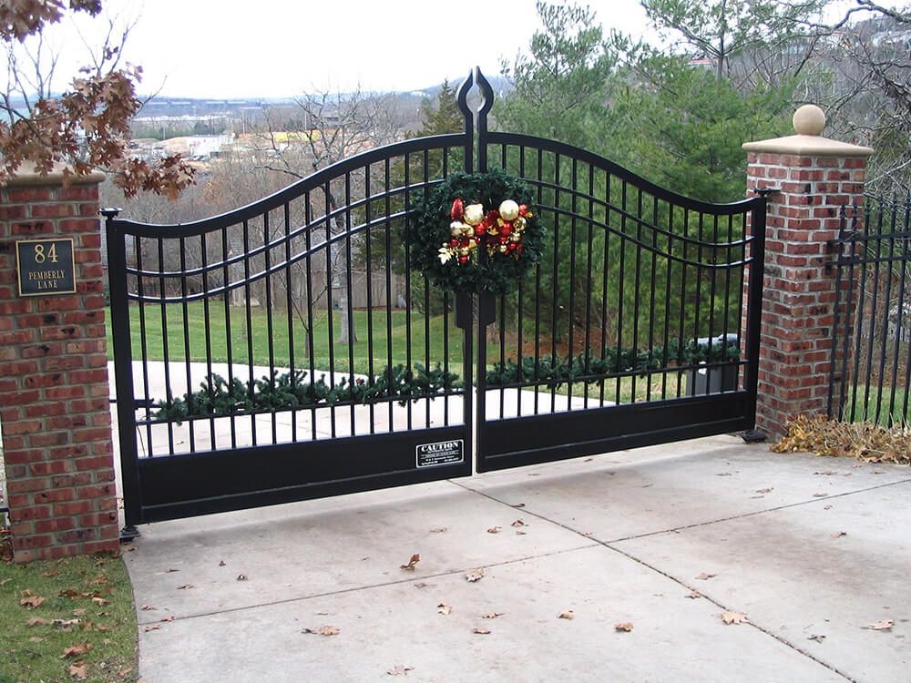 A black gate with a christmas wreath on it