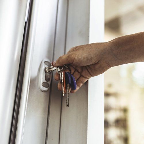 Woman Opening The Front Door — Saint Paul, MN — Kat – Key’s Lock & Safe