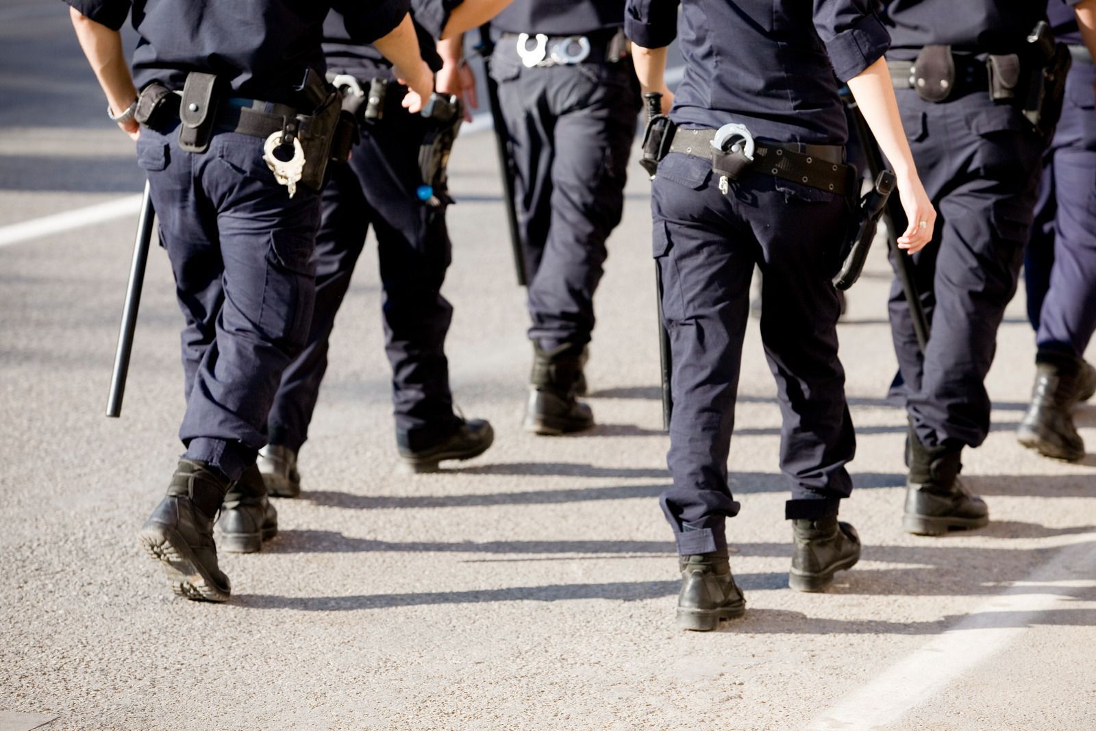 A group of police officers walking down a street