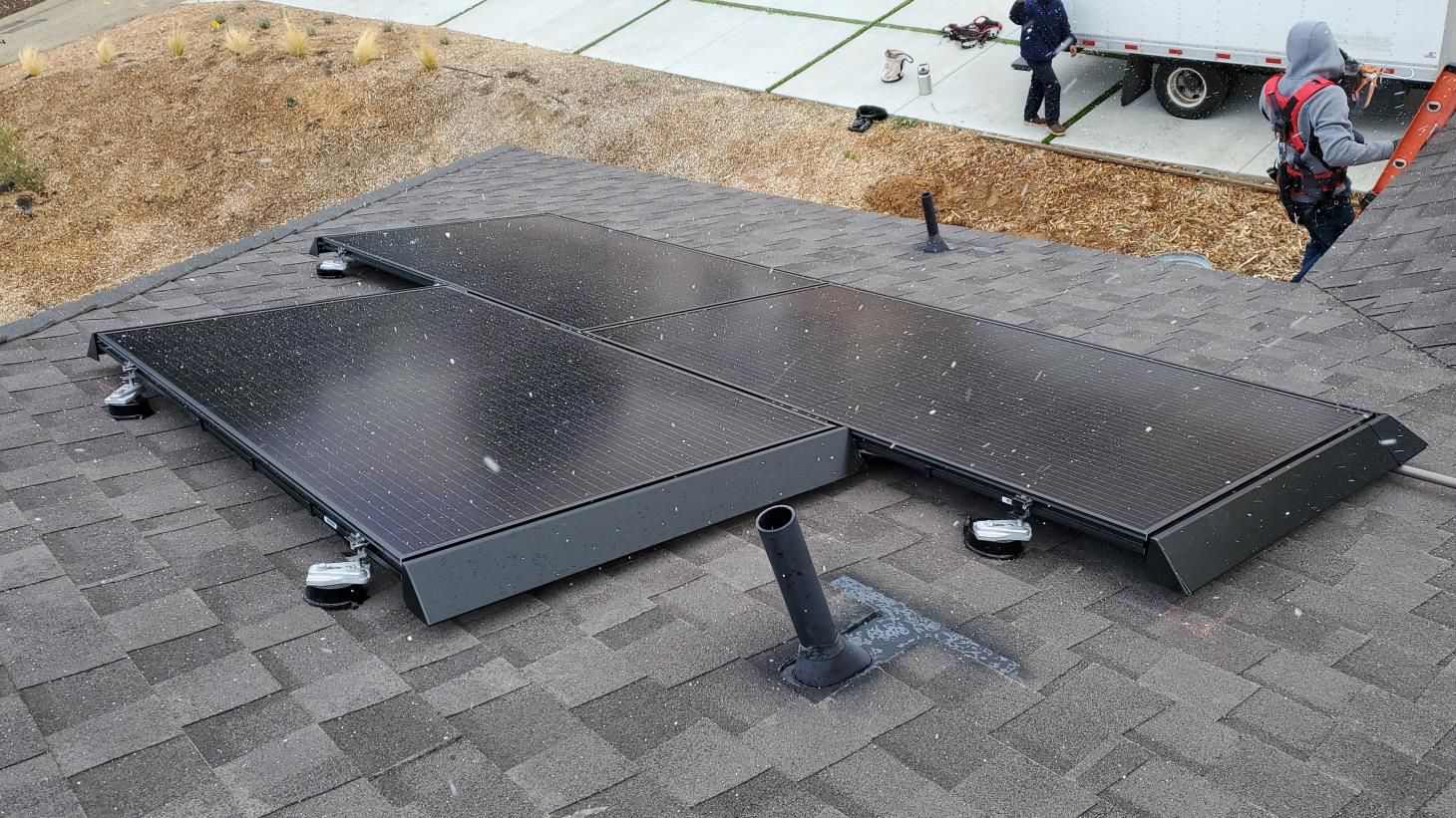 A group of solar panels are sitting on top of a roof.