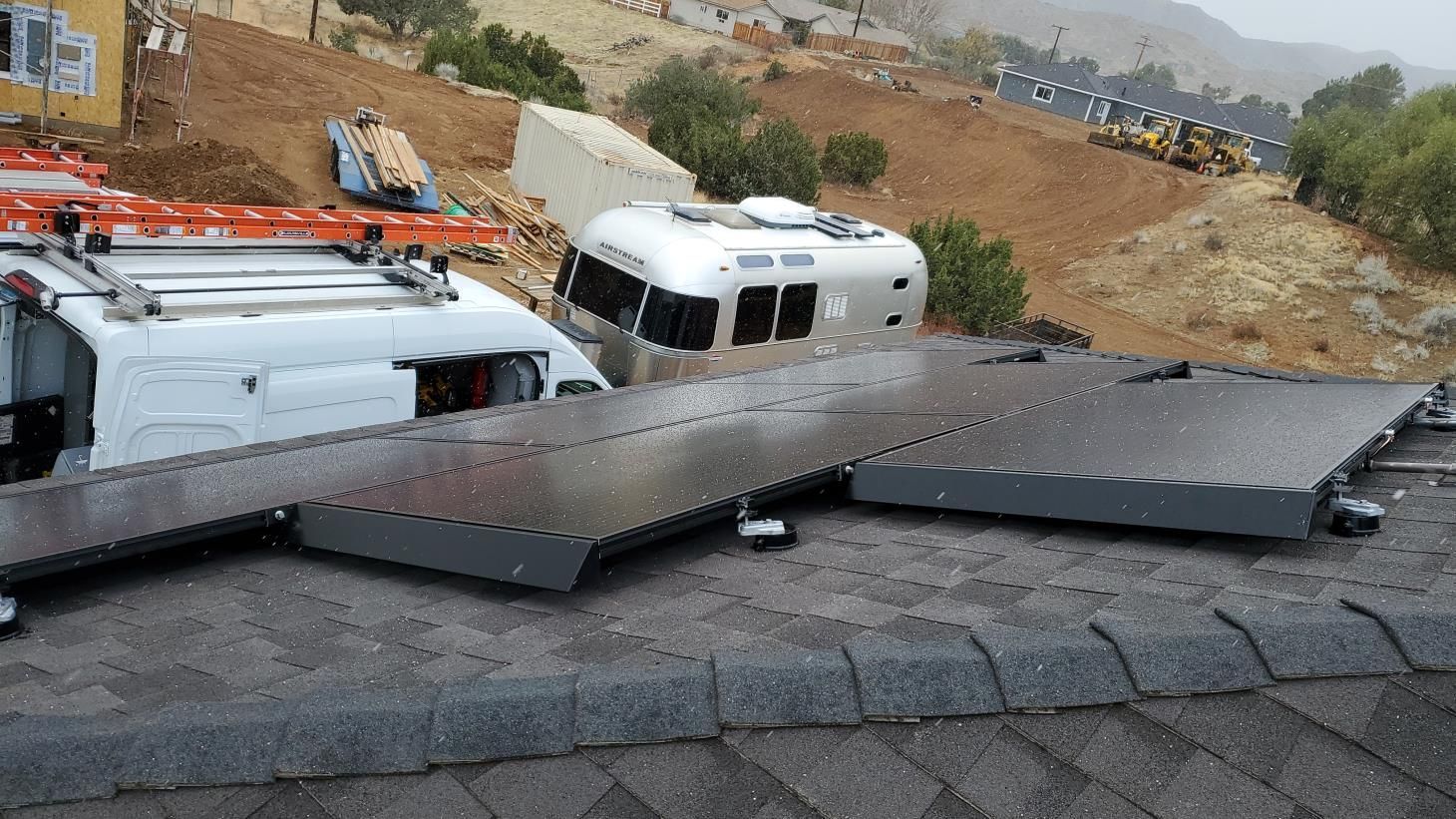 A bunch of solar panels are sitting on top of a roof.