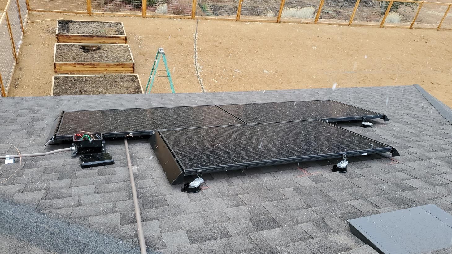 A row of solar panels are sitting on top of a roof.